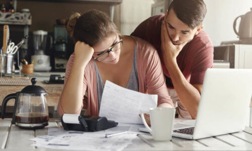 Confused Couple Looking Over Health Cover